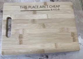 This Place Ain't Cheap B.Y.O.B CUTTING BOARD